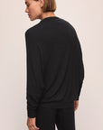 Model wears Cozy Time Mock Neck Pullover in Black.