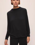 Model wears Cozy Time Mock Neck Pullover in Black.