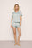 Model is wearing Inez Washable Silk Printed Short PJ Set in Waves Memorable Blue/Navy