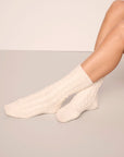 Model wearing cozy socks in ivory