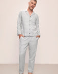 Model is wearing Men's Flannel Long PJ Set in Wintercheck Heather Grey/Ivory.