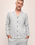 Model is wearing Men's Flannel Long PJ Set in Wintercheck Heather Grey/Ivory.