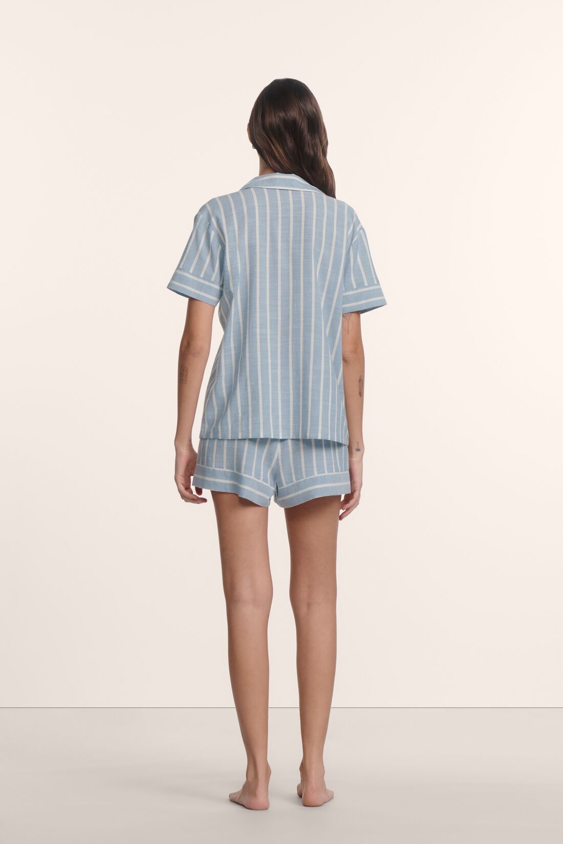 Model is wearing Nautico Shortie Short PJ Set in Classic Stripe Slate Blue/Ivor