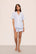 Model is wearing Nautico Shortie Short PJ Set in White/Cornflower Blue