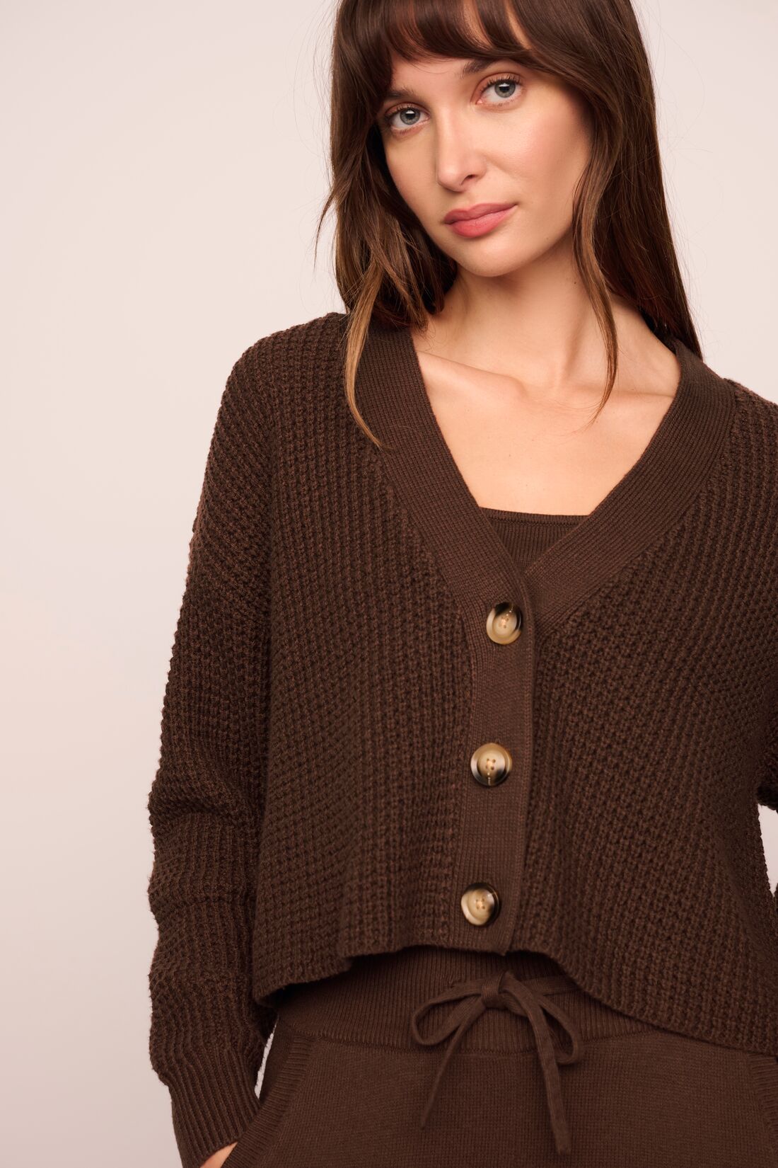 Model is wearing Recycled Sweater Cropped Cardigan  in  Chocolate