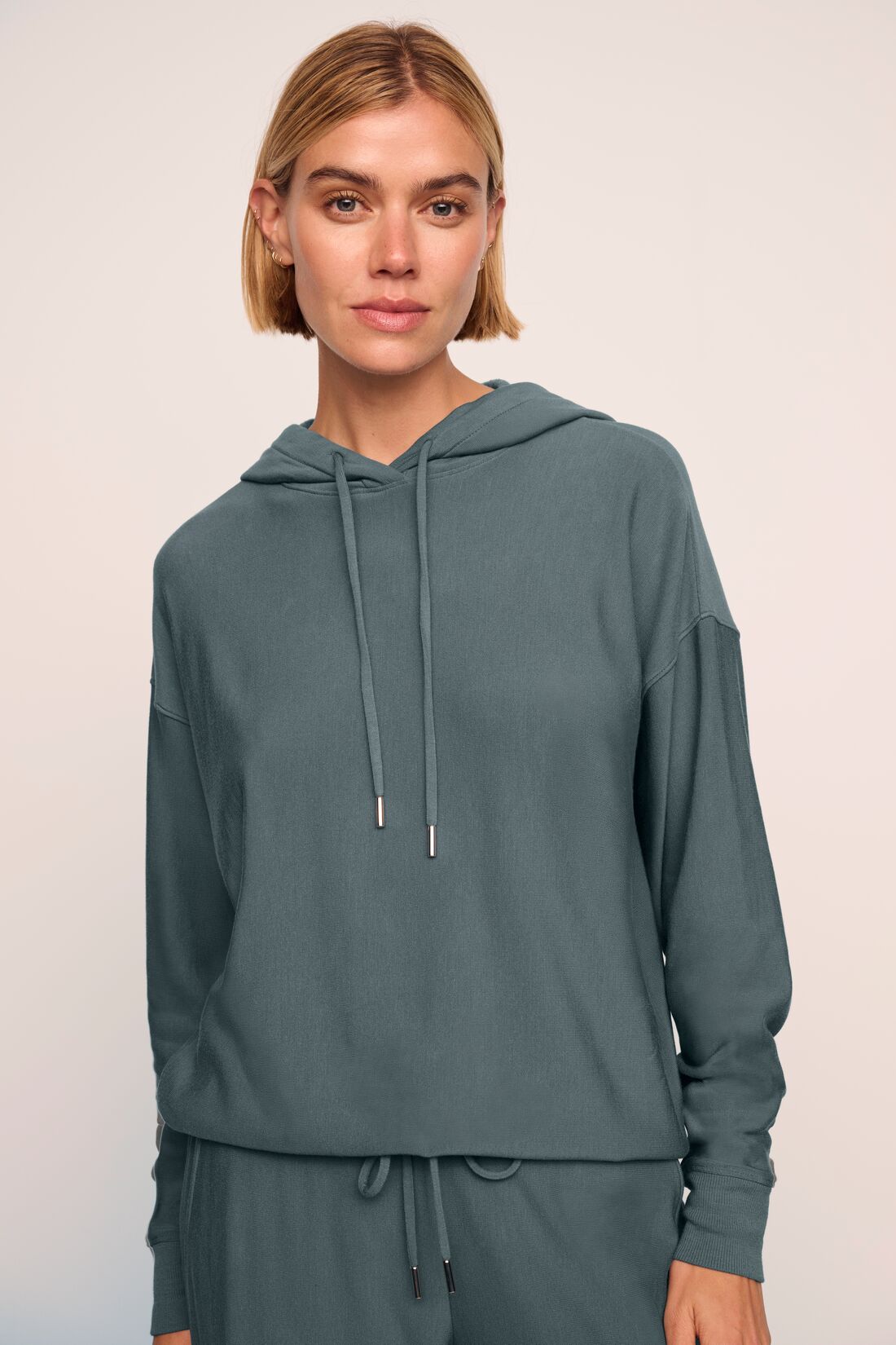 Model is wearing softest sweats hoodie in stone blue