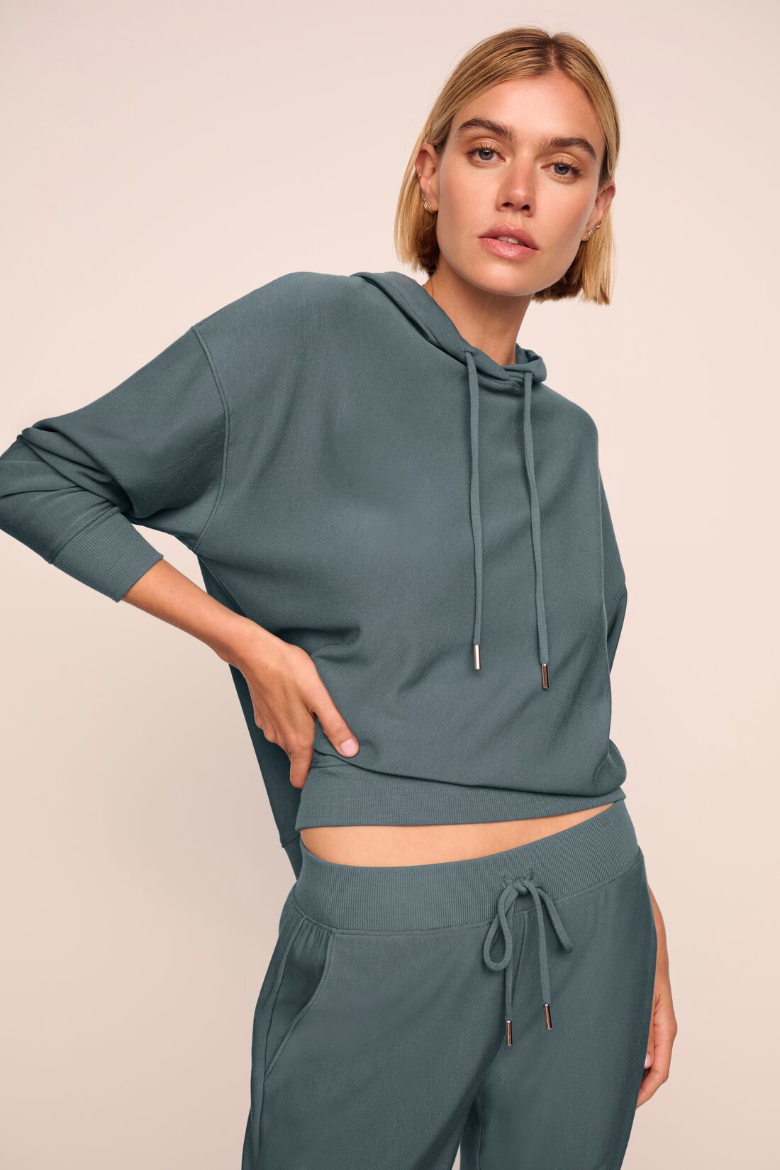 Model is wearing softest sweats hoodie in stone blue