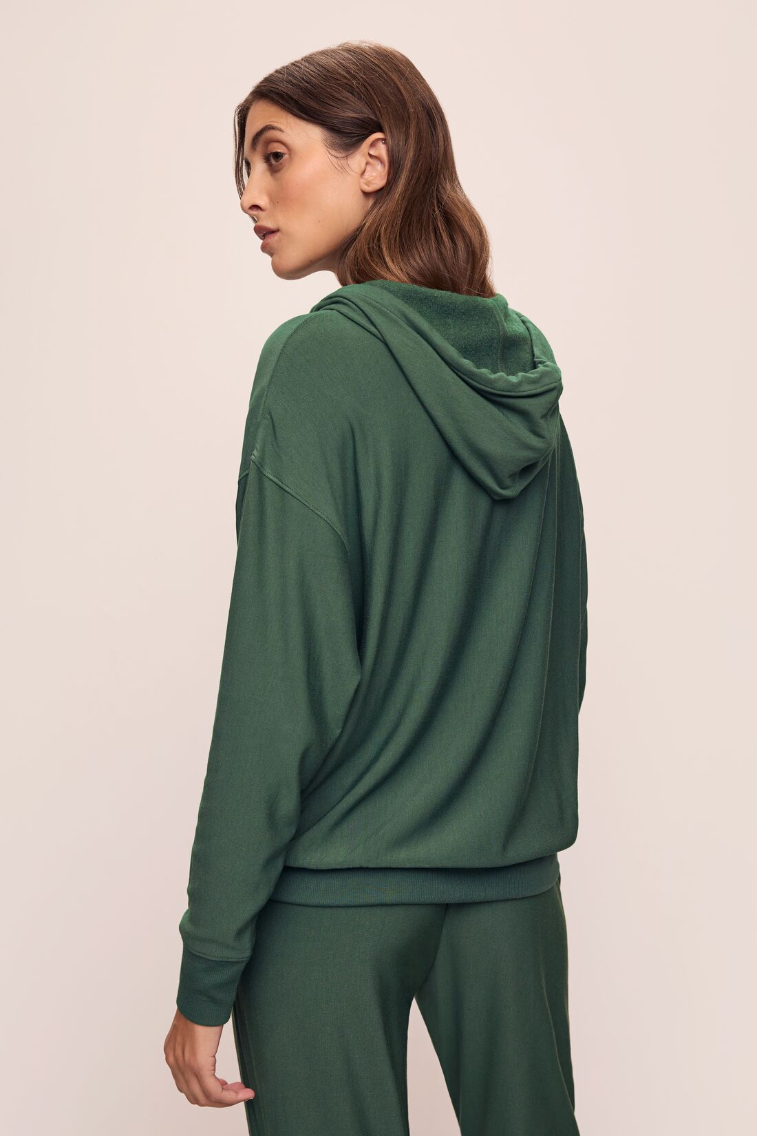 Model wears Softest Sweats Hoodie in Spruce.