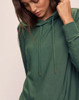 Model wears Softest Sweats Hoodie in Spruce.