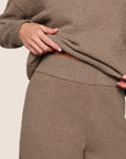 Model is wearing Recycled Boucle Pant  in Deep Taupe