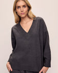 Model wears Recycled Boucle Boyfriend Oversized V-Neck Sweater in Graphite.