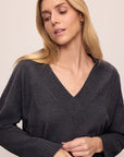 Model wears Recycled Boucle Boyfriend Oversized V-Neck Sweater in Graphite.