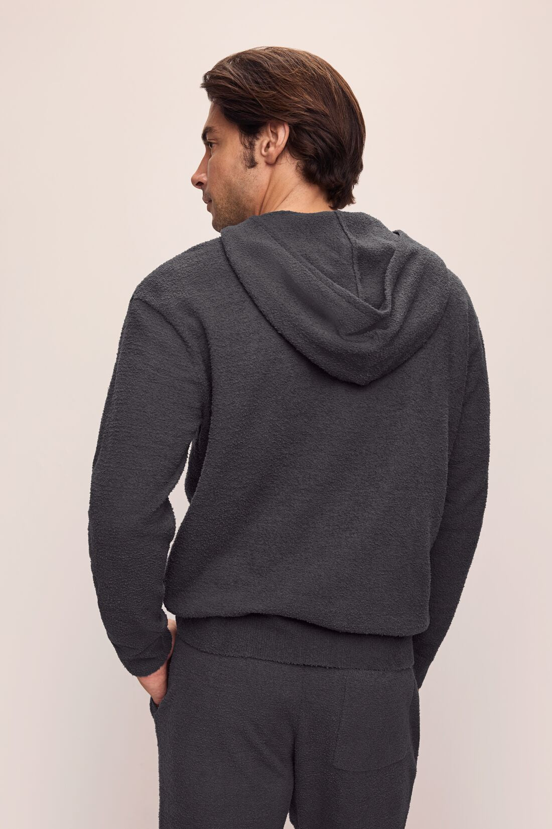 Model is wearing Men's Recycled Boucle Hoodie in Graphite.