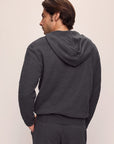 Model is wearing Men's Recycled Boucle Hoodie in Graphite.