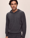 Model is wearing Men's Recycled Boucle Hoodie in Graphite.