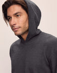 Model is wearing Men's Recycled Boucle Hoodie in Graphite.