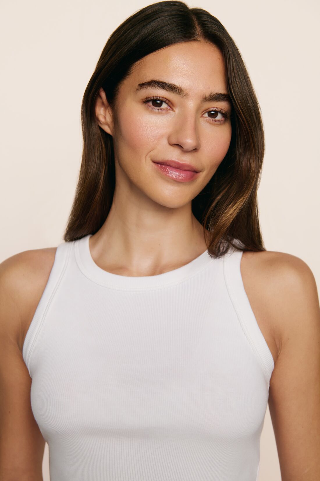 Model is wearing Essential Tank in white