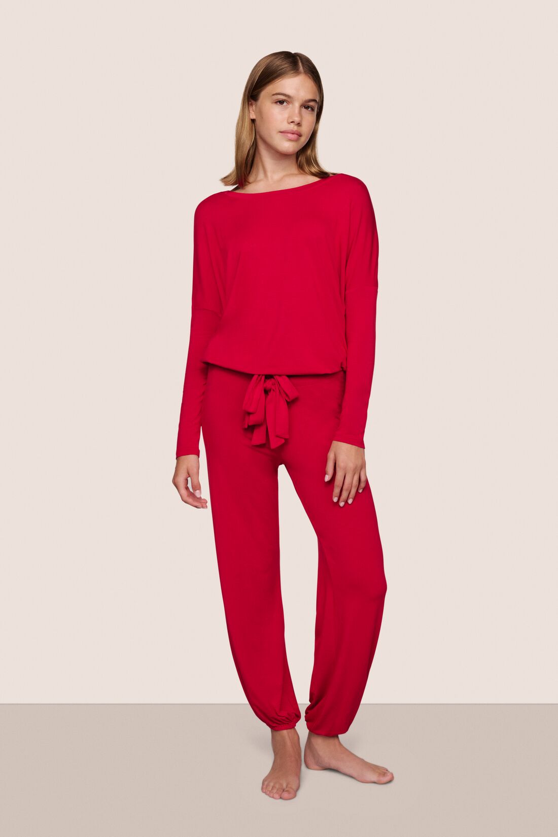 Model is wearing Gisele TENCEL™ Slouchy PJ Set in Holly Red/Ivory