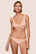 Model is wearing Soft Stretch Lace Thong in Buff