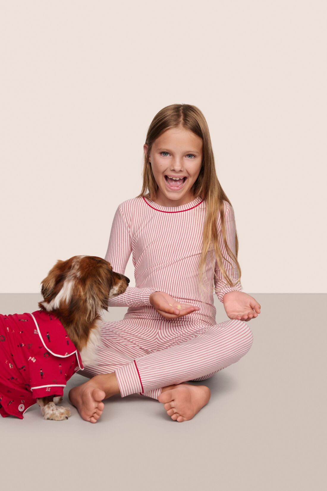 Model is wearing Kids Printed TENCEL™ Modal Unisex Long PJ Set  in Duo Stripe Hollyred/Hollyred