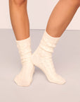 Model wearing cozy socks in ivory