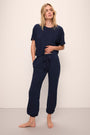 Model wears the Aloe Cotton Pant in Navy.