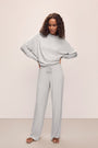 Model wears Cozy Time Wide Leg Pant in Lt. Heather Grey.