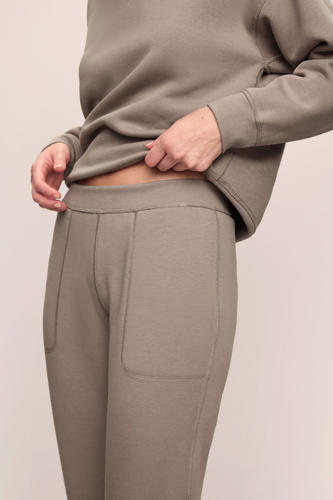 Model wears Reversible Plush Jogger in Toffee.