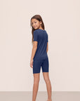 Model is wearing Kids TENCEL™ Modal Unisex Short PJ Set in Navy/Ivory