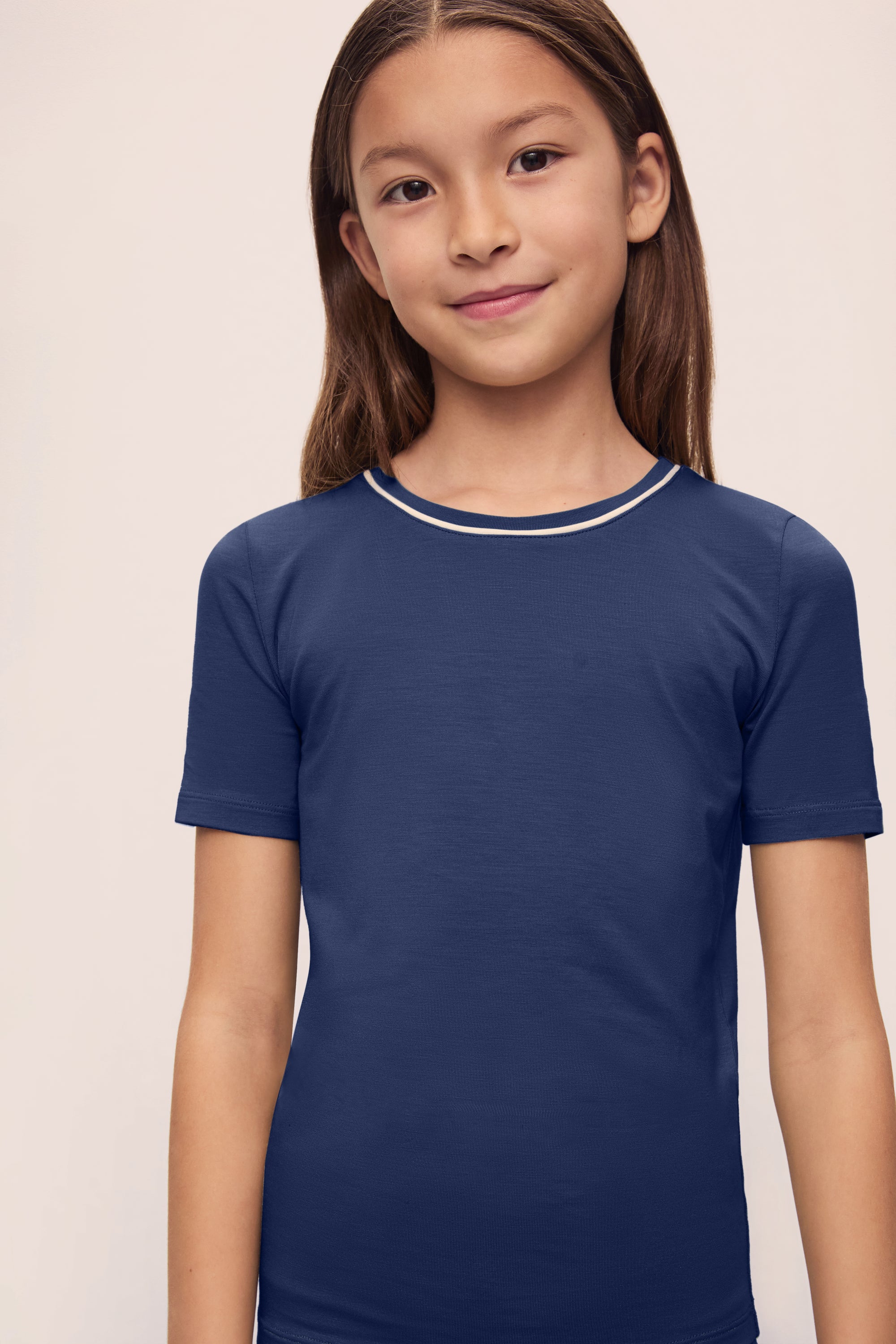 Model is wearing Kids TENCEL™ Modal Unisex Short PJ Set in Navy/Ivory