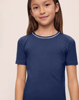 Model is wearing Kids TENCEL™ Modal Unisex Short PJ Set in Navy/Ivory