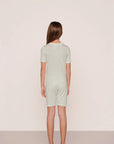 Model is wearing Kids Printed TENCEL™ Modal Unisex Short PJ Set in Tide Dot Ivory/Ivory