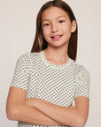 Model is wearing Kids Printed TENCEL™ Modal Unisex Short PJ Set in Tide Dot Ivory/Ivory