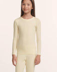 Model is wearing Kids TENCEL™ Modal Unisex Long PJ Set in Buttercream/Ivory