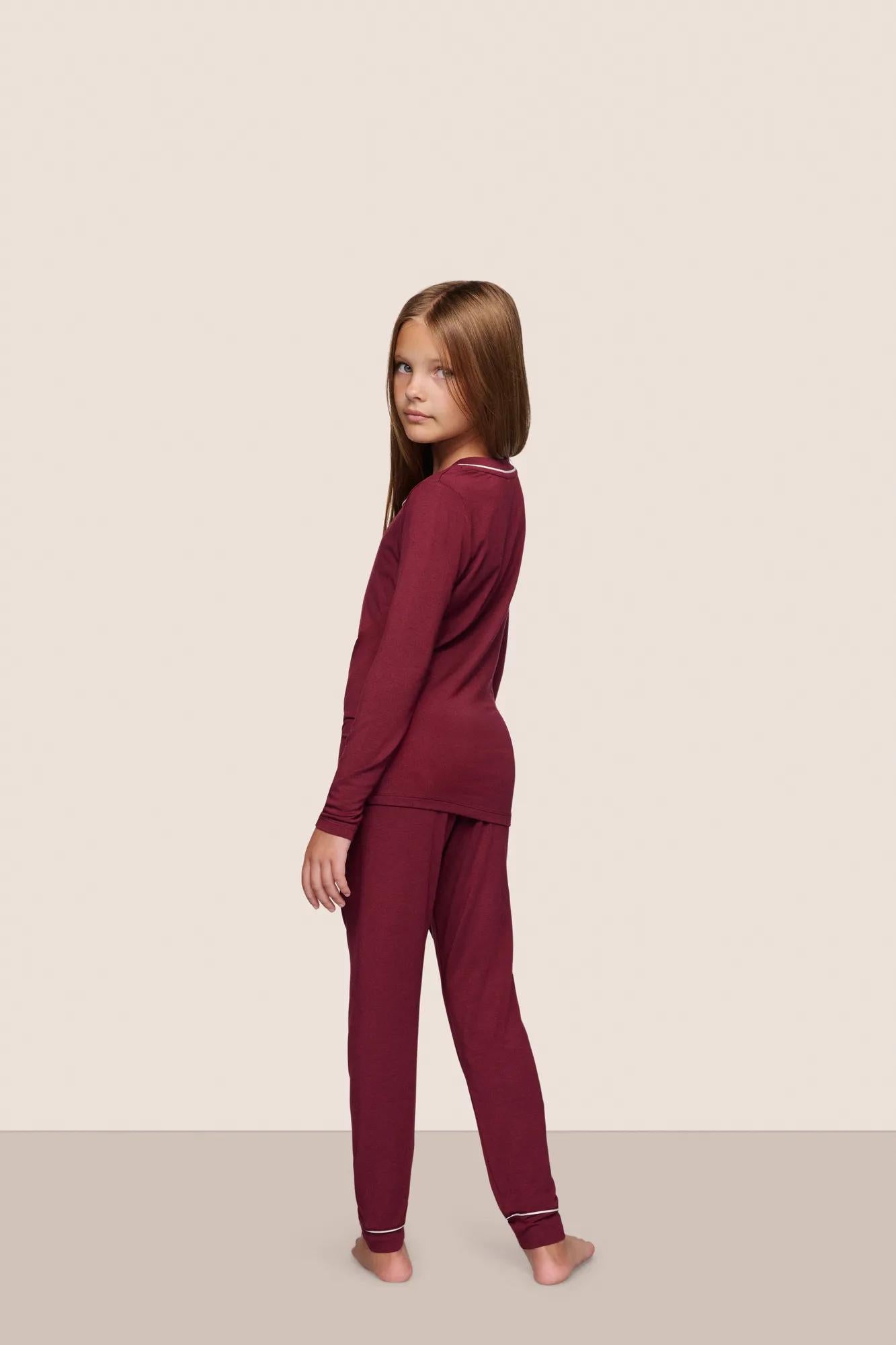 Model is wearing Kids TENCEL™ Modal Unisex Long PJ Set  in Bordeaux/Ivory