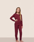 Model is wearing Kids TENCEL™ Modal Unisex Long PJ Set  in Bordeaux/Ivory