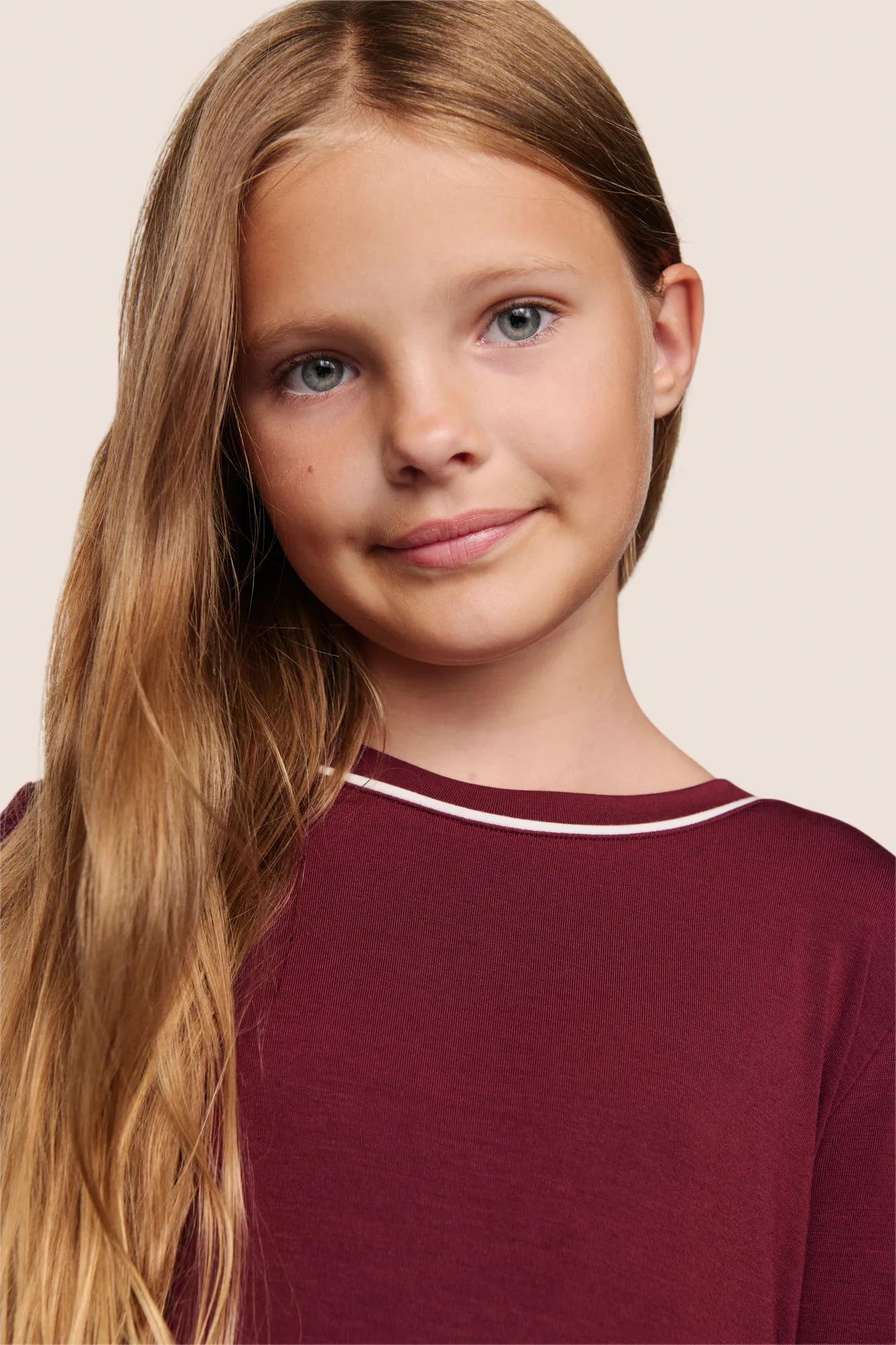 Model is wearing Kids TENCEL™ Modal Unisex Long PJ Set  in Bordeaux/Ivory