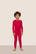 Model is wearing Kids TENCEL™ Modal Unisex Long PJ Set  in Holly Red/Ivory