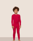 Model is wearing Kids TENCEL™ Modal Unisex Long PJ Set  in Holly Red/Ivory