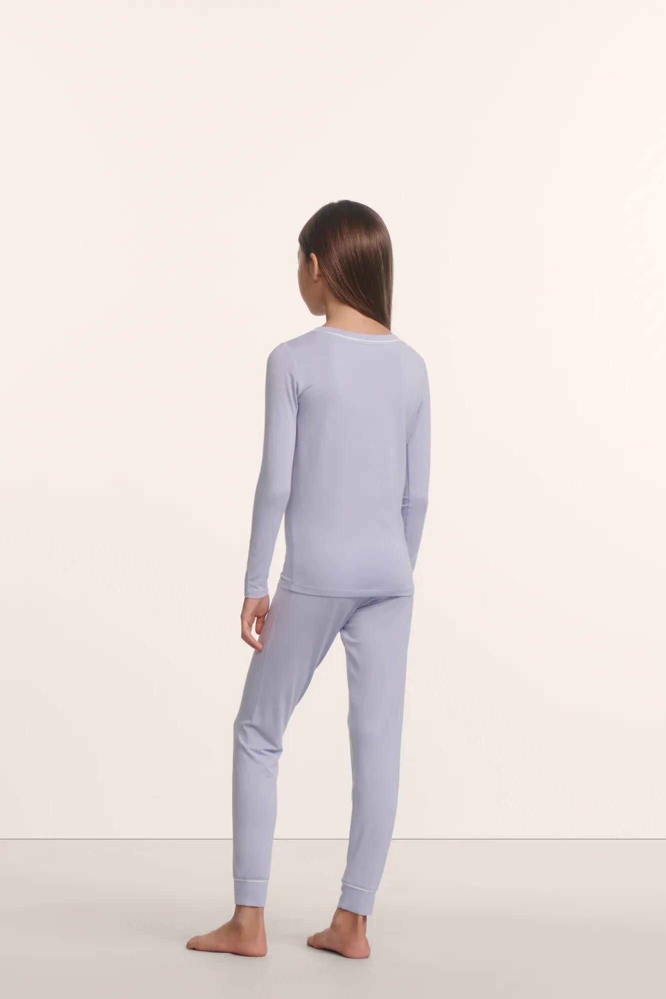 Model is wearing Kids TENCEL™ Modal Unisex Long PJ Set in Lavender Dusk/Ivory