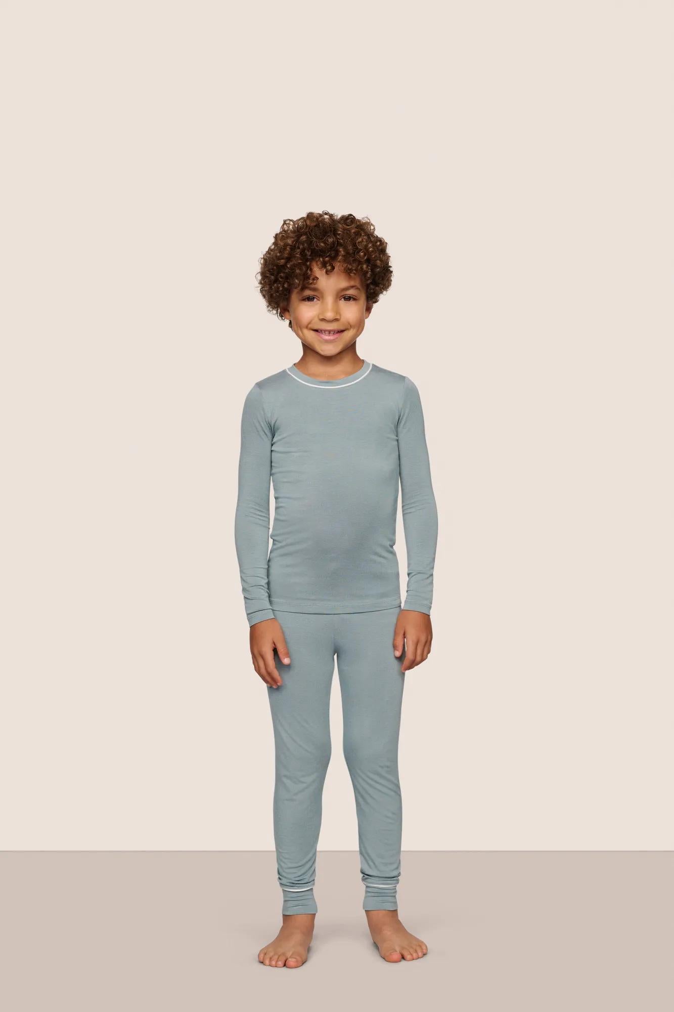 Model is wearing Kids TENCEL™ Modal Unisex Long PJ Set  in Lead/Ivory