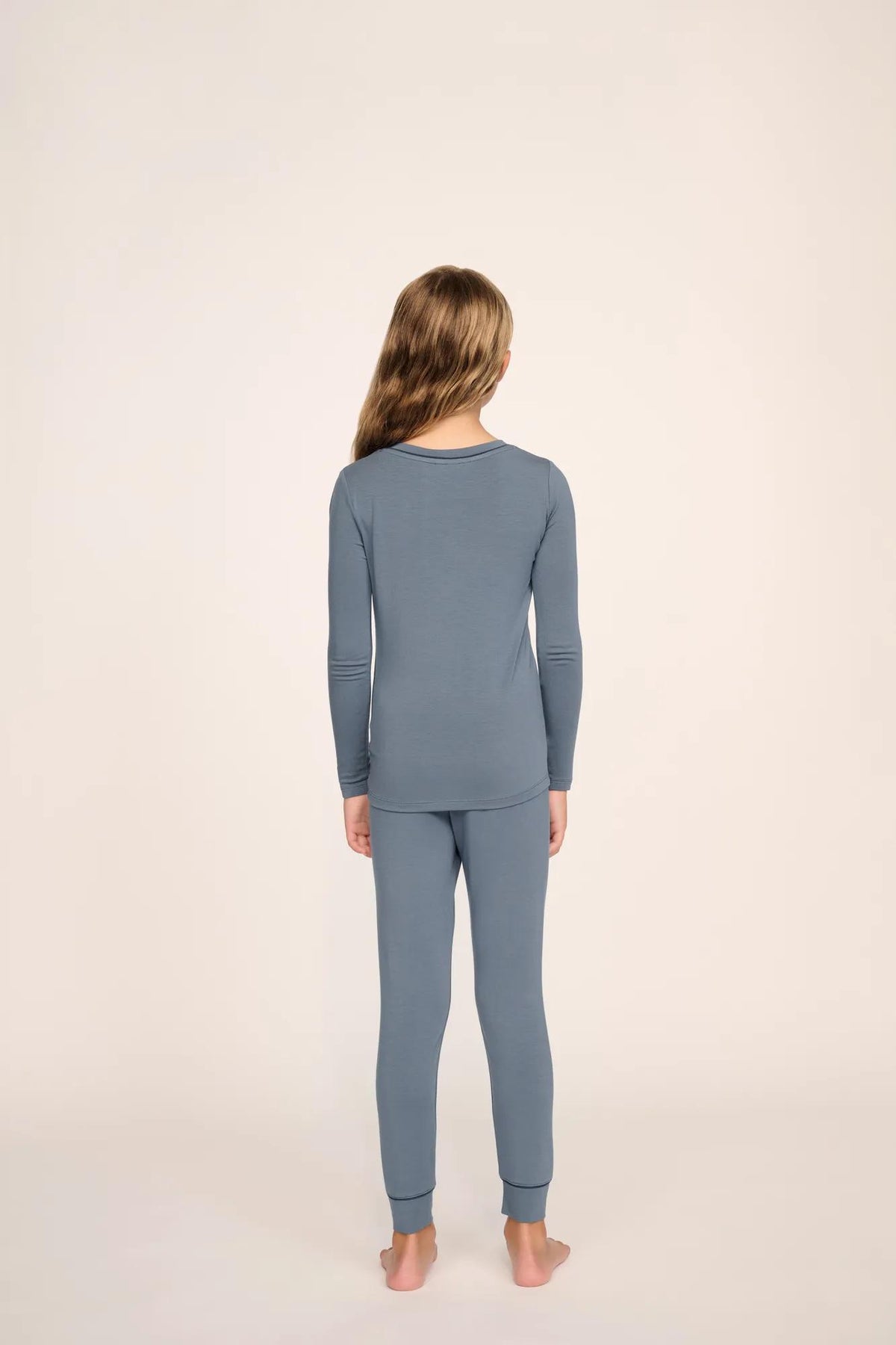 Model is wearing Kids TENCEL™ Modal Unisex Long PJ Set in Moonlight Blue/Navy