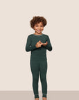 Model is wearing Kids TENCEL™ Modal Unisex Long PJ Set  in Pine/Ivory