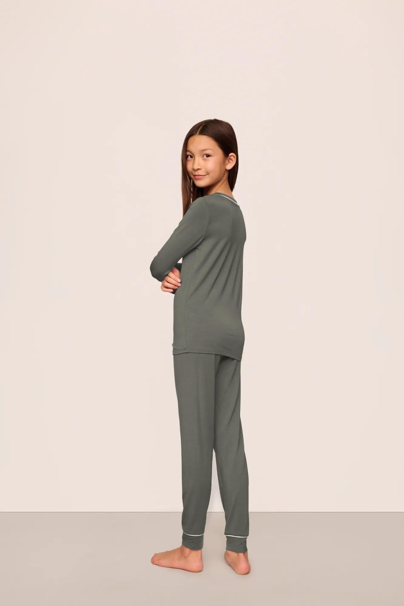 Model is wearing Kids TENCEL™ Modal Unisex Long PJ Set  in Smokey Olive/Ivory