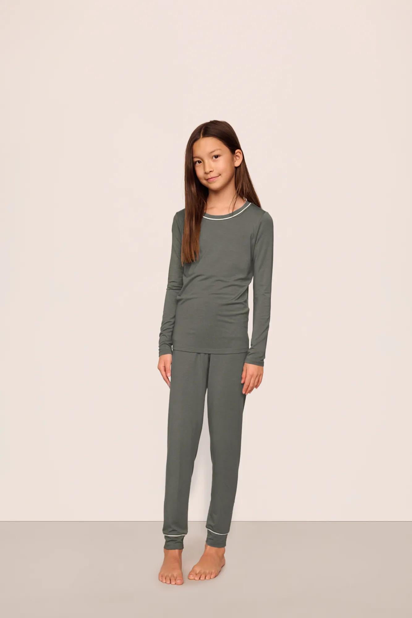Model is wearing Kids TENCEL™ Modal Unisex Long PJ Set  in Smokey Olive/Ivory