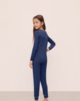 Model is wearing Kids TENCEL™ Modal Unisex Long PJ Set in Navy/Ivory