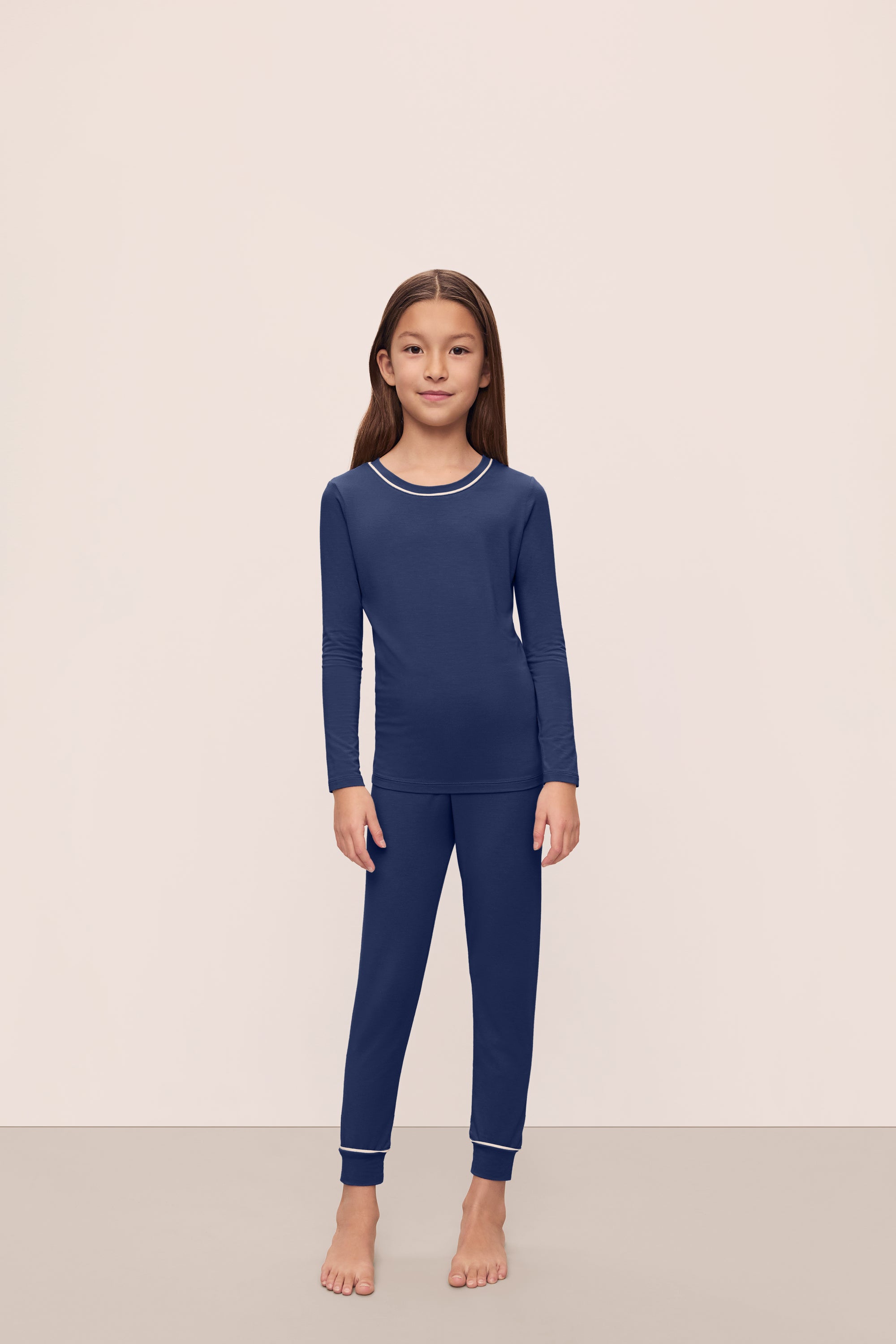 Model is wearing Kids TENCEL™ Modal Unisex Long PJ Set in Navy/Ivory