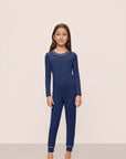 Model is wearing Kids TENCEL™ Modal Unisex Long PJ Set in Navy/Ivory