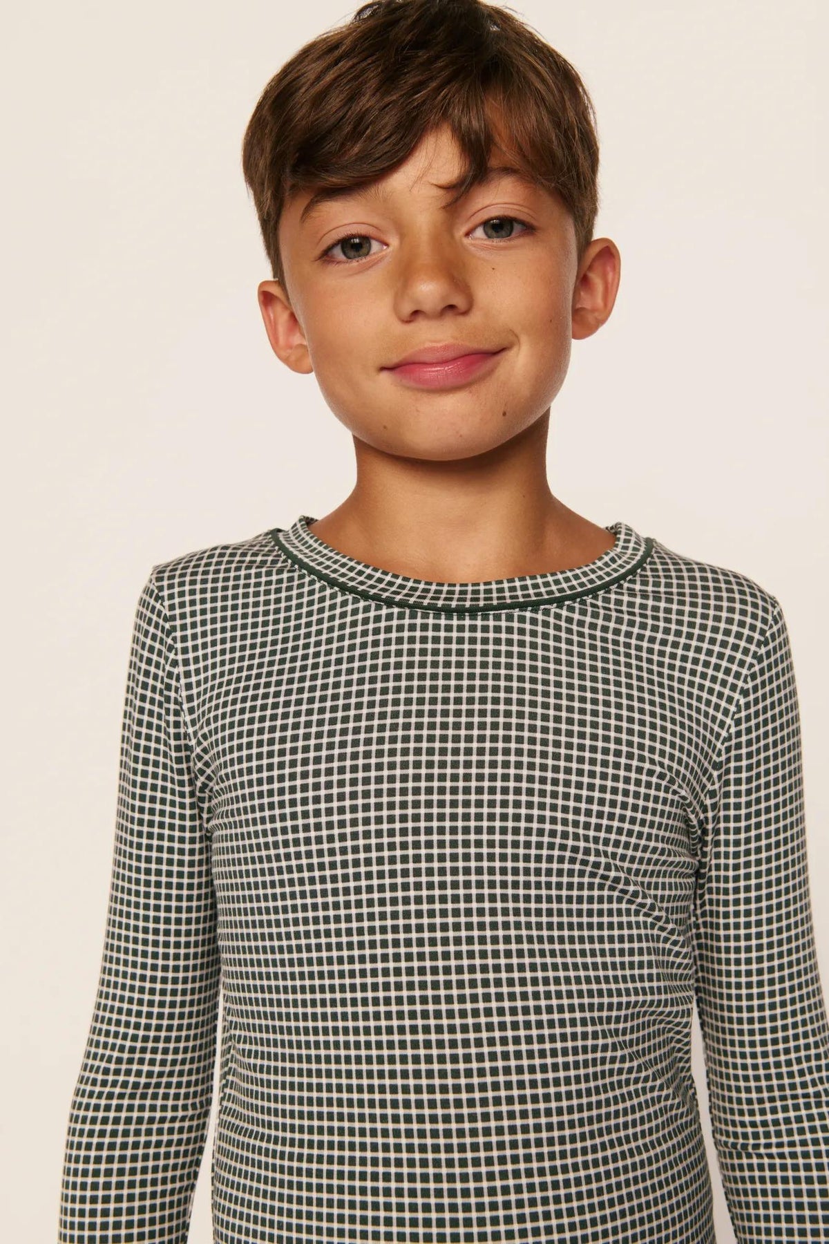 Model is wearing Kids Printed TENCEL™ Modal Unisex Long PJ Set in Cabin Check Ivory/Pine