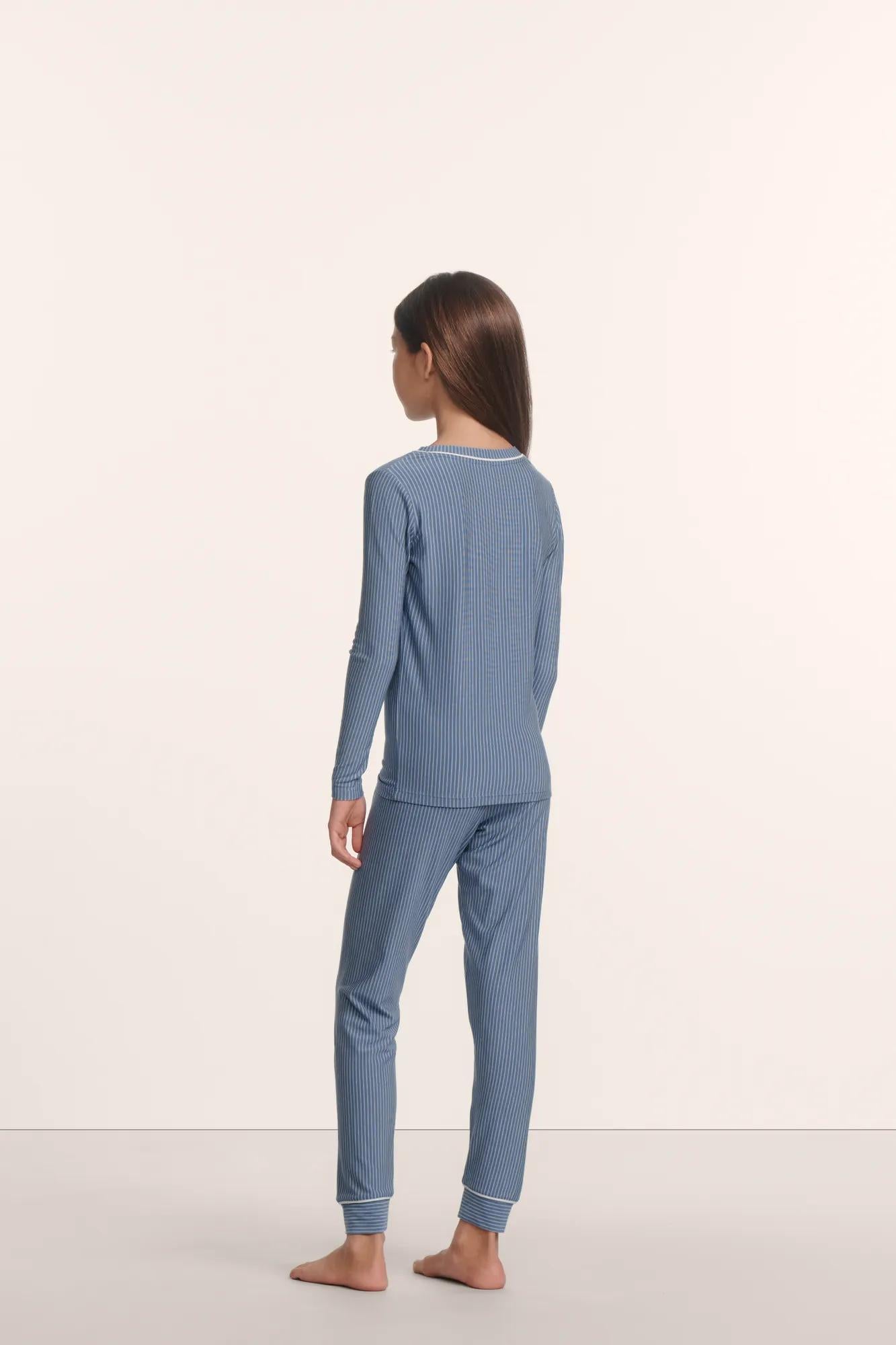 Model is wearing Kids Printed TENCEL™ Modal Unisex Long PJ Set in Duo Stripe Slate Blue/Ivory